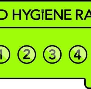 Bright green food hygiene rating sticker displaying "Food Hygiene Rating" text. Five circled numbers from 0 to 5; number 5 is bolded, indicating "Very Good.". Food Safety in Catering