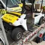 Event Medical Cover 6 Ambulance golf cart marked "North West Medical Team" on a trailer, parked in front of emergency vehicles. The scene conveys readiness and support.